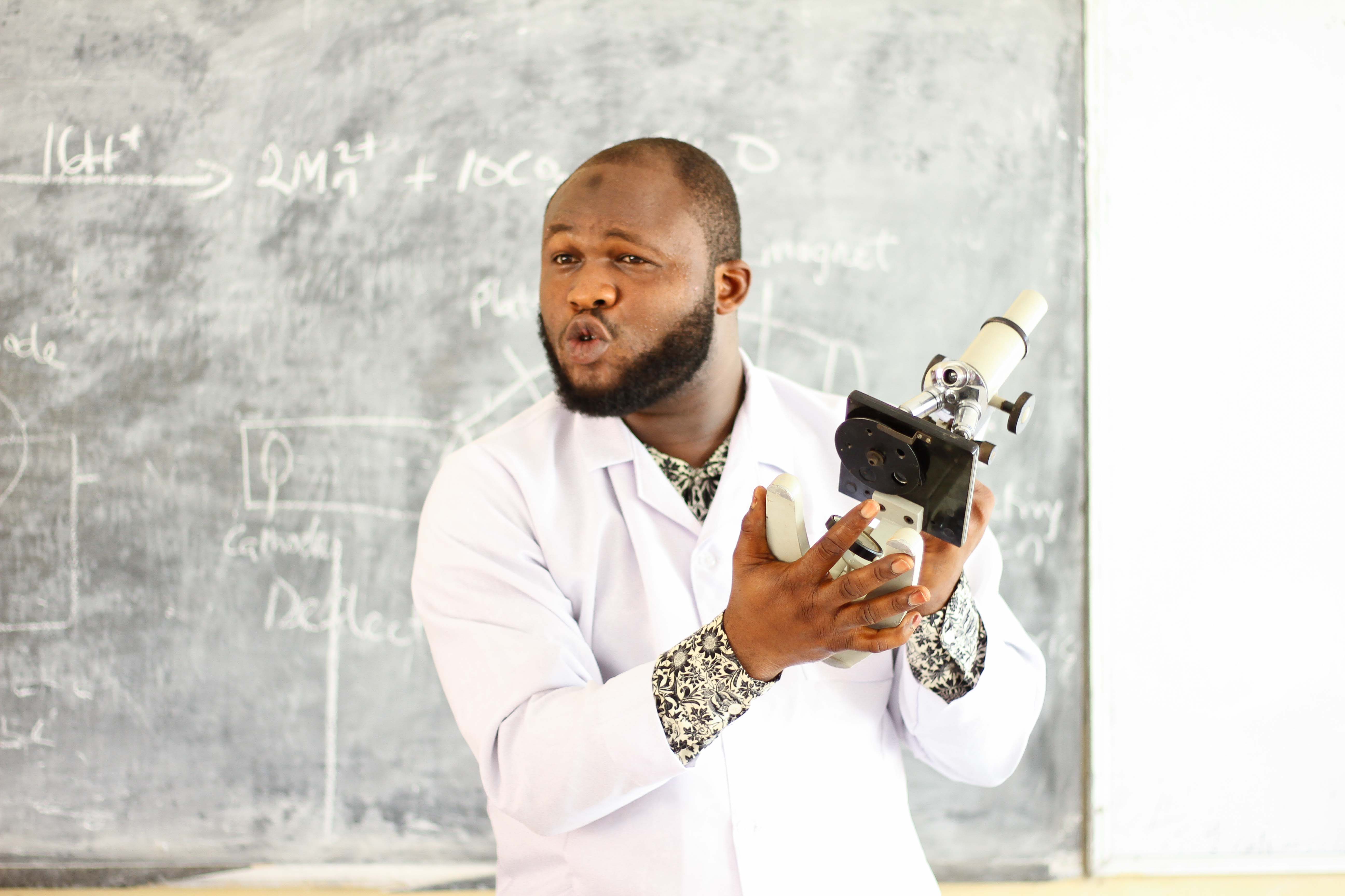 Lecturer teaching the students how to use a Microscope